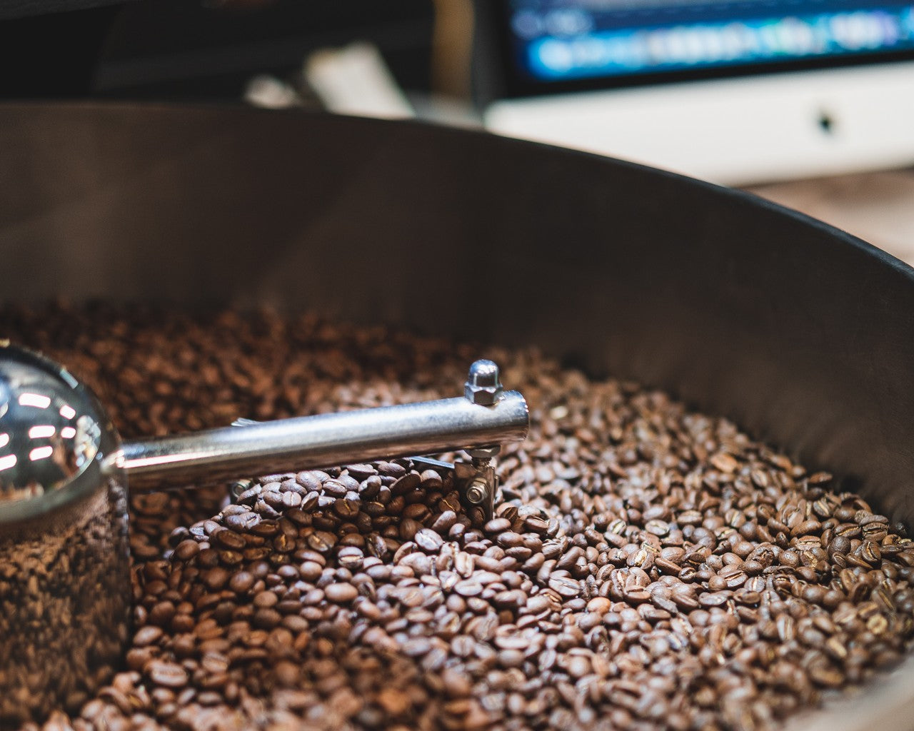 Beans inside a roasting machine highlighting their quality and medium roast colour