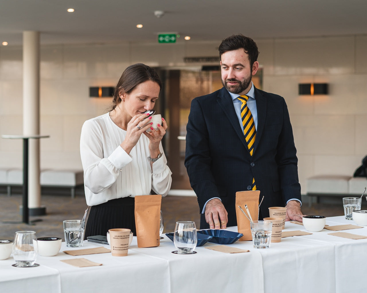 Corporate guests smelling coffee beans during specialty coffee tasting event organised by coffee tasting guide