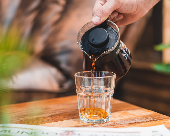 A filter coffee being poured in inviting third wave coffee shop