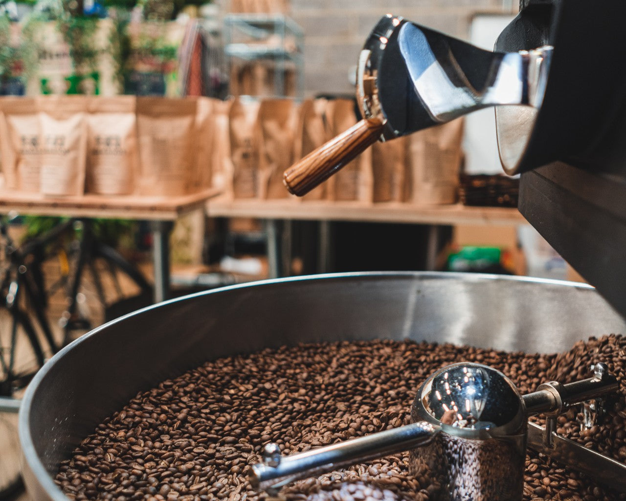 Freshly roasted coffee beans at a roastery ready to be packaged for subscription delivery
