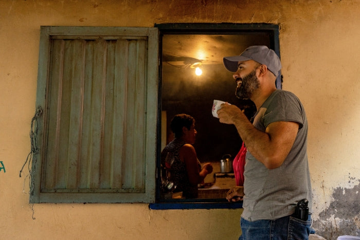 Photo of Hermanos owner Santiago drinking coffee in Colombian coffee triangle