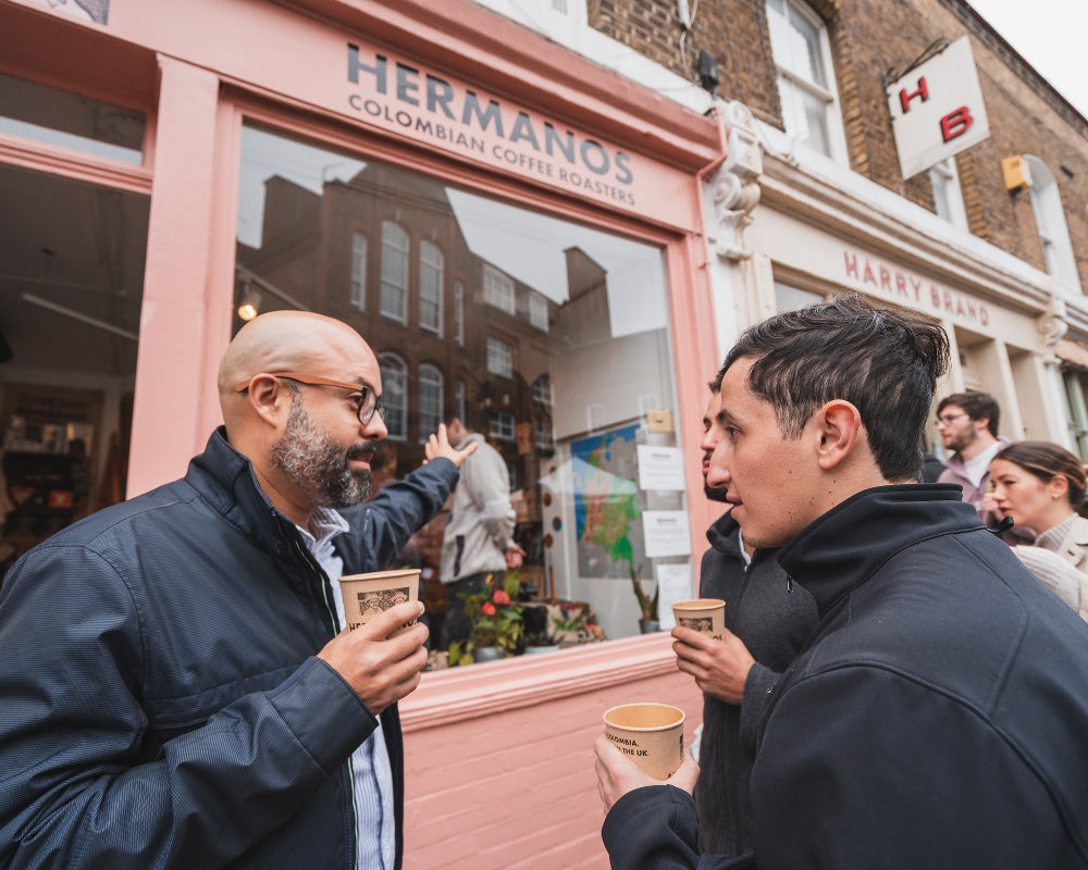 Santiago giving the El Vergel team a tour of Hermanos specialty coffee shops